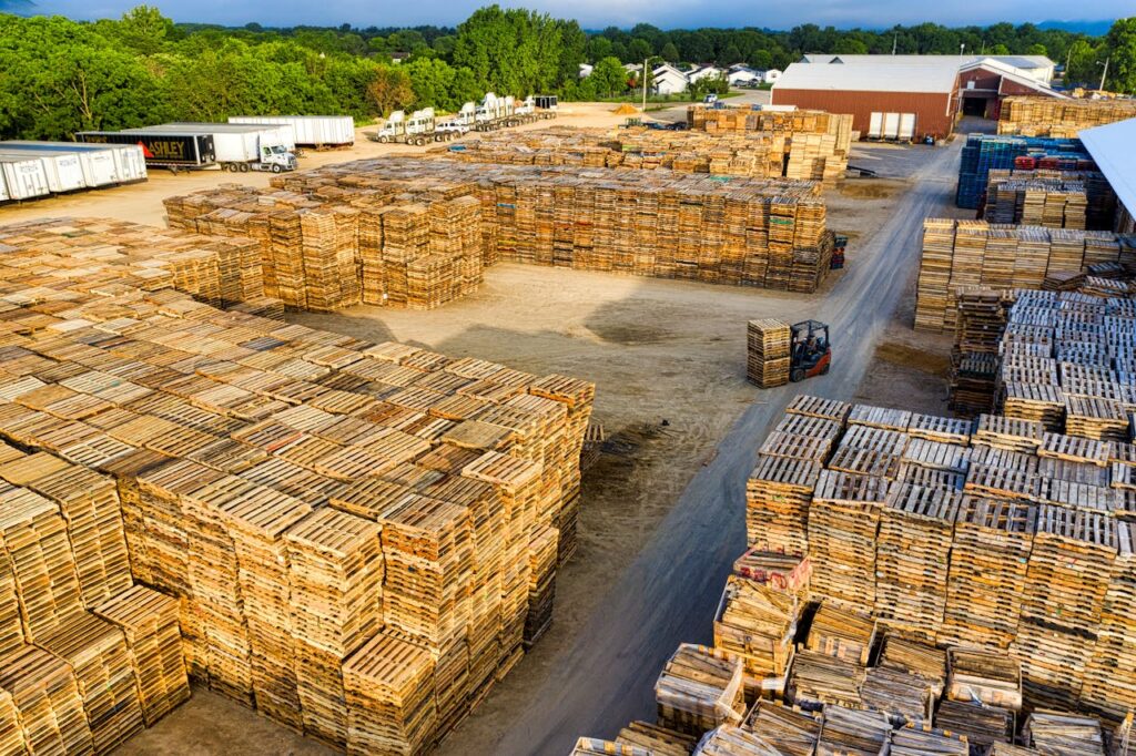 pexels photo 9565565 Aerial view showcasing large stacks of wooden pallets in an outdoor storage facility in Lake City, MN.